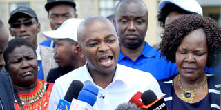 FKF president Nick Mwendwa, flanked by his deputy Doris Petra