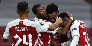 Arsenal's English midfielder Joe Willock (second right) celebrates with teammates after scoring his team's second goal