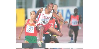 Saif Saaeed Shaheen of Qatar clears a hurdle