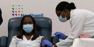 Sandra Lindsay(left), a nurse at Long Island Jewish Medical Center, is inoculated with the Covid-19 vaccine.