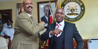 Acting Nairobi Governor Benson Mutura is congratulated by NMS Director Mohamed Badi 