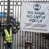 A security man stands at the main gate of a Lagos market to prevent access in compliance with Covid-19 measures.