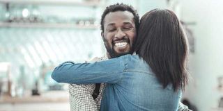 Man hugging woman