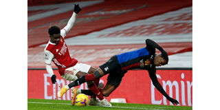 Arsenal forward Bukayo Saka (left) vies with Crystal Palace forward Wilfried Zaha