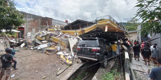 Rescuers search for survivors at a collapsed building in Mamuju, Indonesia on January 15, 2021.