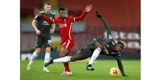 Liverpool midfielder Georginio Wijnaldum (centre) fouls Manchester United midfielder Paul Pogba