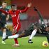 Liverpool midfielder Georginio Wijnaldum (centre) fouls Manchester United midfielder Paul Pogba