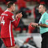 Liverpool captain Jordan Henderson speaks to referee