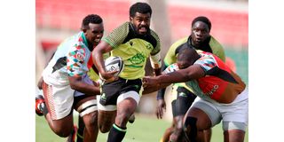 Kabras Sugar's Jone Kubu takes on Kenya Harlequins defence