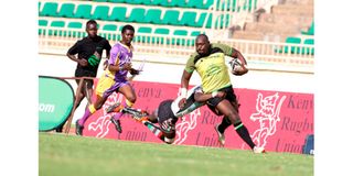 Kabras Sugar Captain Dan Sikuta (right) breaks away from Kenya Harlequins Evin Asena 