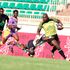 Kabras Sugar Captain Dan Sikuta (right) breaks away from Kenya Harlequins Evin Asena 