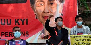 Protesters hold signs in Yangon
