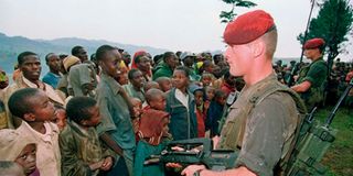 Two French soldiers stand guard at the Nyarushishi Tutsis refugees’ camp on April 30, 1994. 