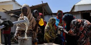 Displaced Somalis queue for food