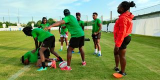 Members of the national women’s rugby team train in Tokyo under strength and conditioning coach Samuel Kimotho