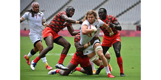 USA's Joe Schroeder (second right) tries to break through Kenya's defence 