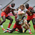 USA's Joe Schroeder (second right) tries to break through Kenya's defence 