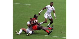 USA's Martin Iosefo (left) tackles Kenya's Billy Odhiambo
