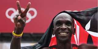 Kenya's Eliud Kipchoge celebrates after winning the men's marathon