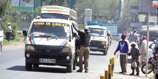 A matatu picking passengers. 