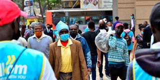 Nairobi residents walk along Tom Mboya Street