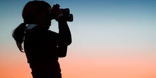 woman holding binoculars