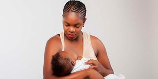 Woman cuddles baby 