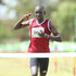 Charles Mneria crosses the finish line to win the men's 10km race during Kenya Prisons Cross Country