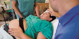 A woman in a delivery room.