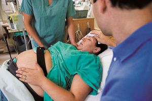 A woman in a delivery room.