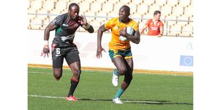 Kenya's Jeff Oluoch (left) chases down an Australian opponent 