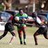 Oscar Simiyu of KCB is tackled by Patrice Agunda and Won Chebo of Kenya Harlequin