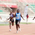 Maximilla Imali (centre) charges past her competitors in 100m semi-final heat 
