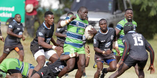 KCB's Alvin "Buffa" Otieno (centre) is tackled by Mwamba's Charles Kuka as Anthony Omondi (right) closes in 