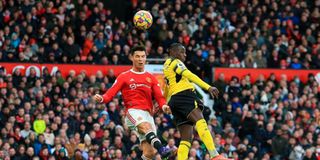 Manchester United striker Cristiano Ronaldo jumps up to head the ball with Watford defender Hassane Kamara