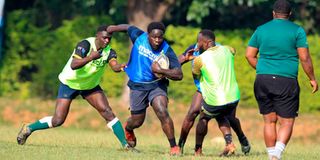 Kabras Rugby prop Ephraim Odour (centre) charges between teammates