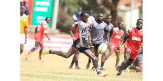 Samuel Omollo of Catholic University "Monks" in action against Shamas Foundation 