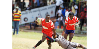 Dan Ochieng' of Shamas Foundation (left) charges past Elly Ojwang' of Catholic University "Monks"