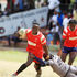 Dan Ochieng' of Shamas Foundation (left) charges past Elly Ojwang' of Catholic University "Monks"