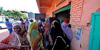 Sudanese buy bread from a bakery 