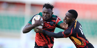 Kenya Chipu right centre Mathias Osimbo (left) vies with Uganda's left wing Steven Kalema