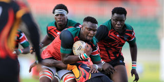 Kenya Chipu left lock Persian Kolian charges past Uganda's Herbert Champara 