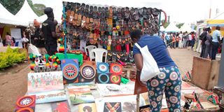 A woman admires artworks at the Africities cultural business and entertainment village 