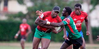 Kenya Simbas Vincent Onyala charges past teammate Geoffrey Ominde