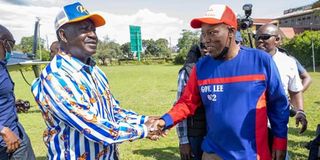 Nakuru Governor Lee Kinyanjui (right) receiving Raila Odinga