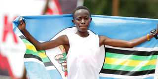 Kenyatta University's Diana Wanza celebrates after winning the women's 10,000 metres final