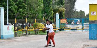 Kilifi county residents walk outside the Pwani Oil Company plant