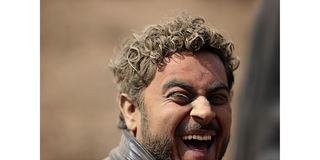 A rally fan smiles inside dust at Kedong stage in Naivasha