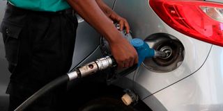 An attendant at a petrol station in Nairobi fuels a customer’s car