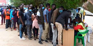 Members of the public queue to register as voters in Eldoret.